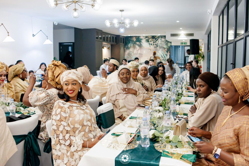 Nigerian traditional wedding reception with guests in coordinated attire